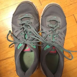 NIKE gray, teal, and pink running shoes
